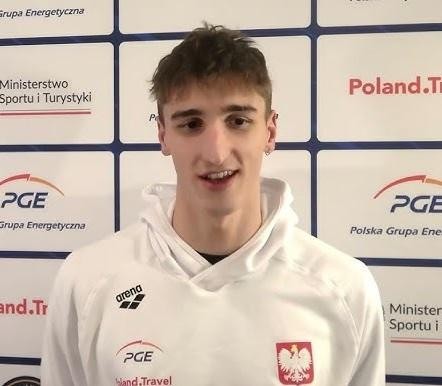 Zbliżenie na twarz Ksawerego Masiuka, polskiego pływaka, z determinacją widoczną podczas zawodów, z kroplami wody na skórze.