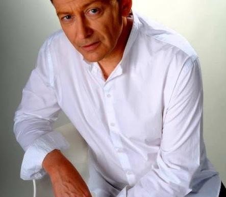 Jacek Borkowski w domowym zaciszu, oddający się pasji gotowania lub relaksujący się w otoczeniu rodzinnym, ukazujący jego prywatne życie i zaangażowanie domowe.