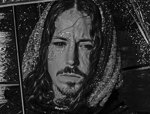 Michał Szpak w zbliżeniu, na scenie, z intensywnym wyrazem twarzy i w ekstrawaganckim stroju, ukazujący jego charyzmę i teatralność występu.